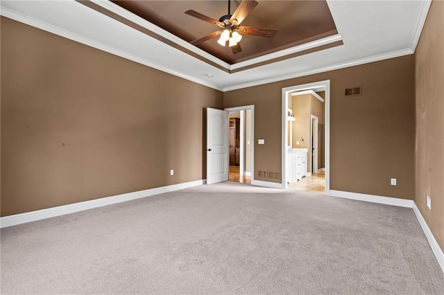 unfurnished room with crown molding, ceiling fan, a tray ceiling, and light carpet