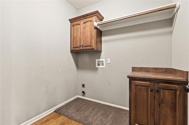 laundry room featuring cabinets, washer hookup, hardwood / wood-style floors, and electric dryer hookup