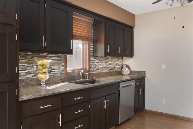 kitchen with sink, dishwasher, backsplash, stone countertops, and light wood-type flooring