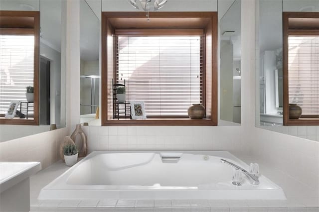 bathroom with a relaxing tiled tub