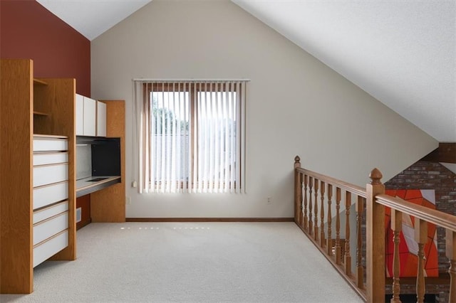 additional living space with light carpet and high vaulted ceiling