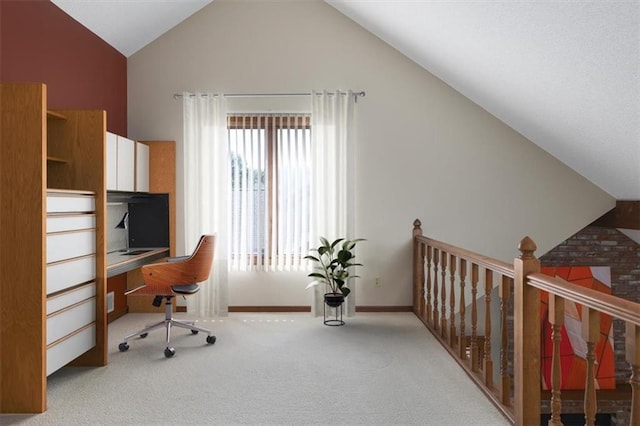 carpeted home office with high vaulted ceiling