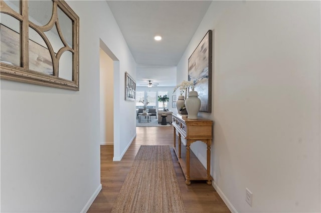 corridor with hardwood / wood-style flooring