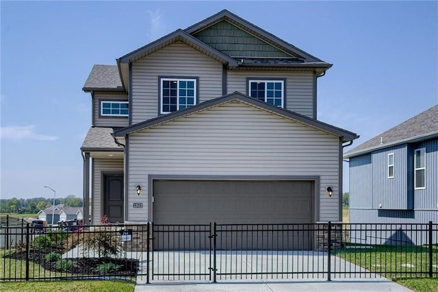 view of front of property with driveway, a fenced front yard, and an attached garage