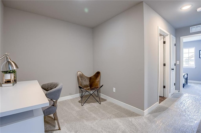 office area with light carpet and baseboards