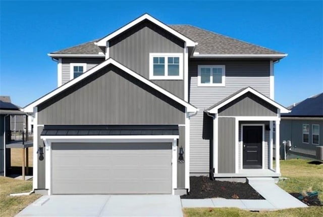 craftsman-style house with metal roof, a garage, a shingled roof, concrete driveway, and a standing seam roof