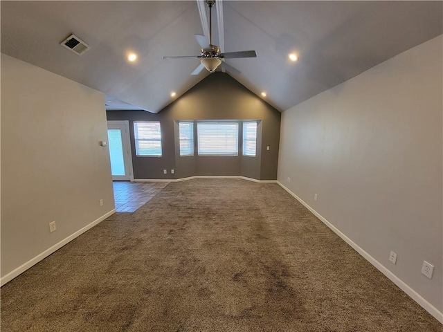 carpeted empty room featuring ceiling fan and vaulted ceiling