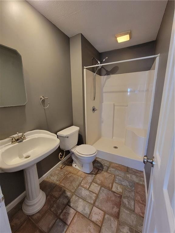 bathroom with a shower and toilet