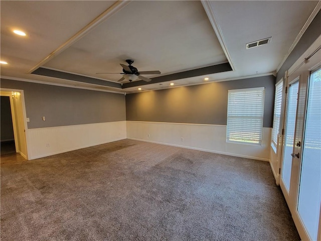 unfurnished room featuring plenty of natural light, ceiling fan, crown molding, and a tray ceiling