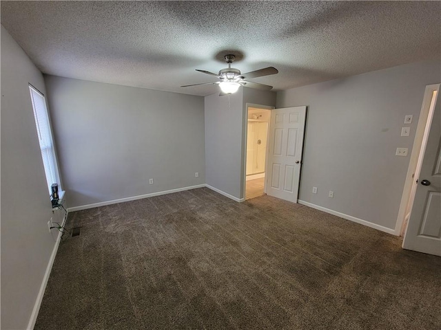 unfurnished bedroom with dark colored carpet, a textured ceiling, and ceiling fan