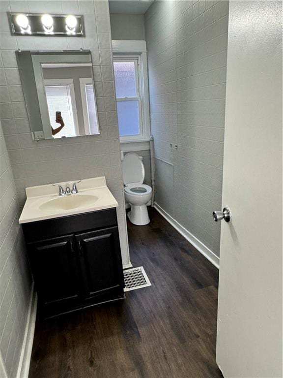 bathroom featuring vanity, toilet, and hardwood / wood-style flooring