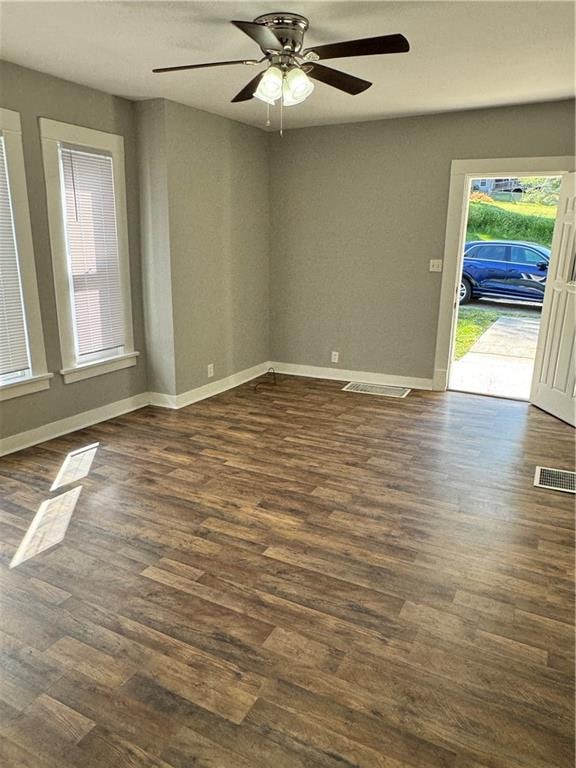 spare room with ceiling fan and dark hardwood / wood-style floors