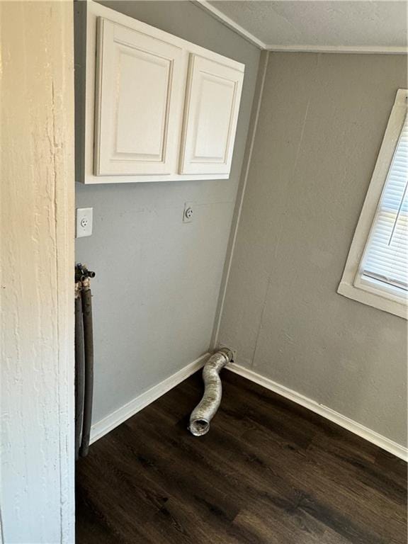 laundry area featuring ornamental molding, hardwood / wood-style floors, cabinets, and electric dryer hookup