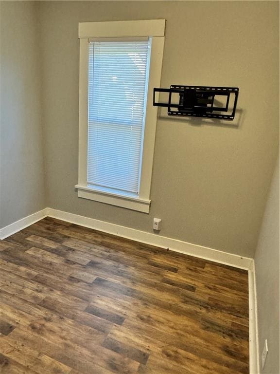 unfurnished room featuring dark hardwood / wood-style flooring