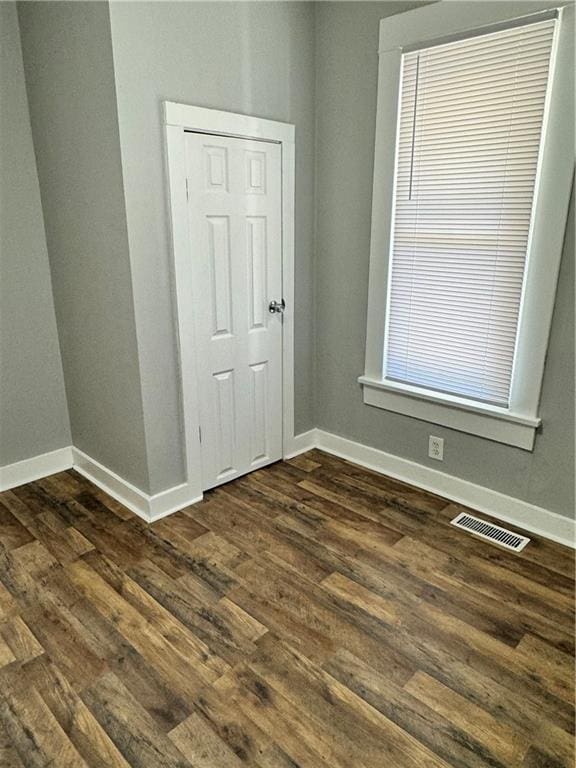 spare room with dark hardwood / wood-style floors