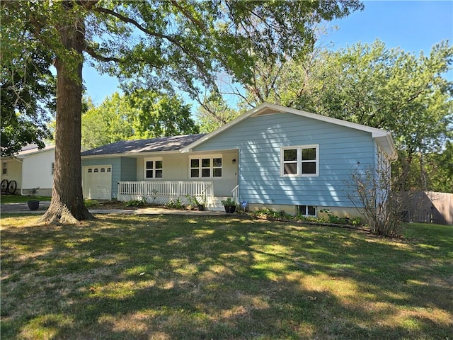 rear view of property with a lawn and a garage