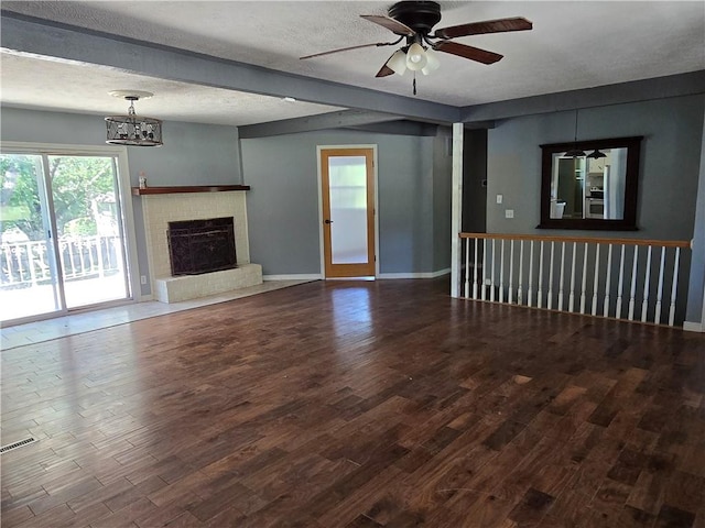 unfurnished living room featuring a textured ceiling, dark hardwood / wood-style floors, and ceiling fan with notable chandelier