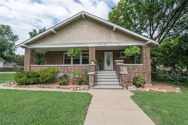 view of front of home with a front lawn and covered porch