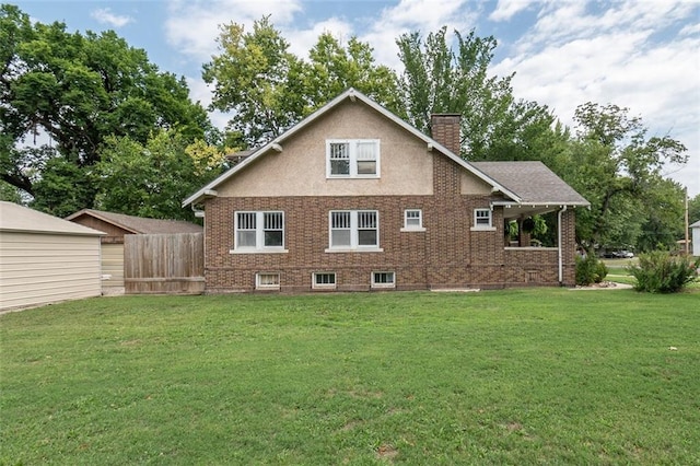 back of house with a lawn