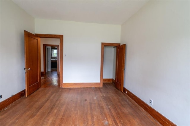 unfurnished bedroom featuring dark hardwood / wood-style floors