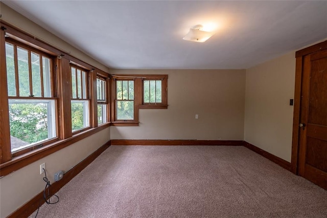 carpeted empty room with plenty of natural light