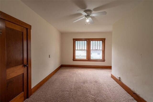 unfurnished room featuring ceiling fan and light carpet