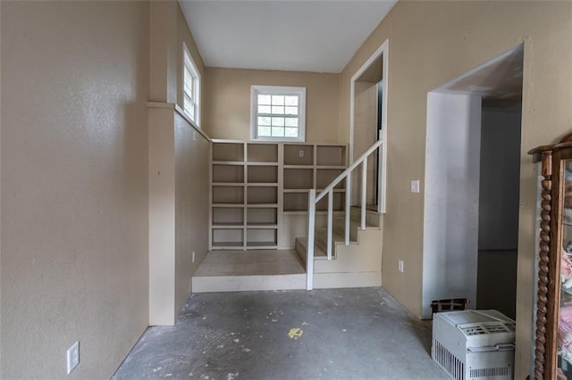 staircase with concrete flooring