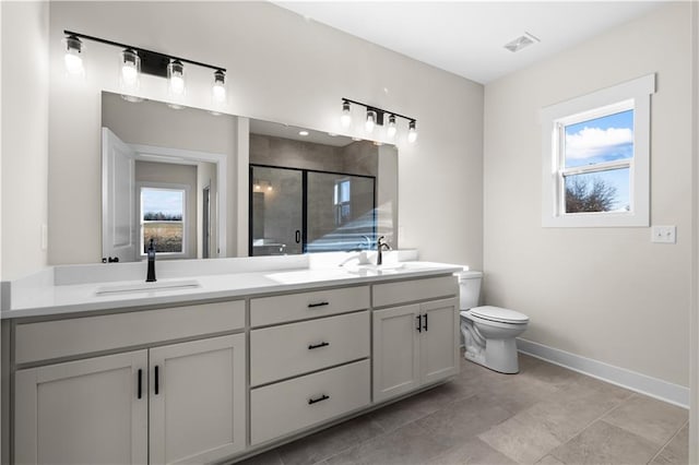 bathroom with an enclosed shower, vanity, and toilet