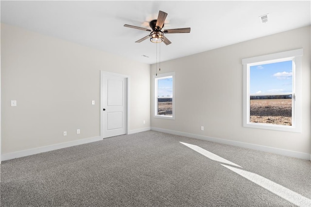 empty room featuring ceiling fan and carpet flooring