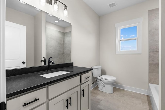 bathroom with toilet, tile patterned flooring, and vanity