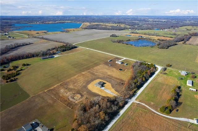 birds eye view of property with a rural view and a water view