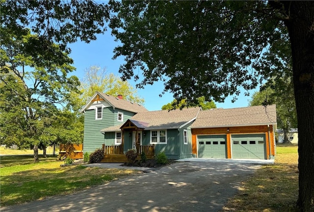 view of front of property featuring a garage and a front lawn