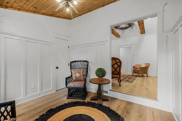 living area with wood ceiling, light hardwood / wood-style floors, and ceiling fan