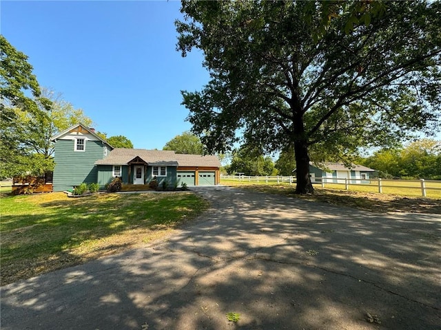 view of front facade featuring a garage and a front lawn