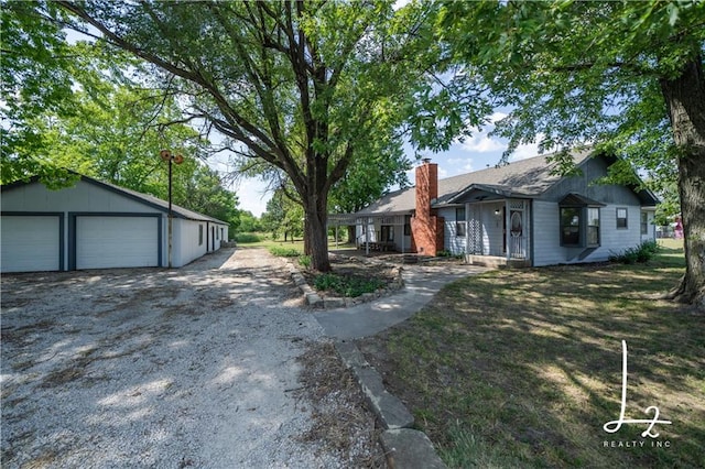 view of property exterior featuring a yard, a garage, and an outbuilding