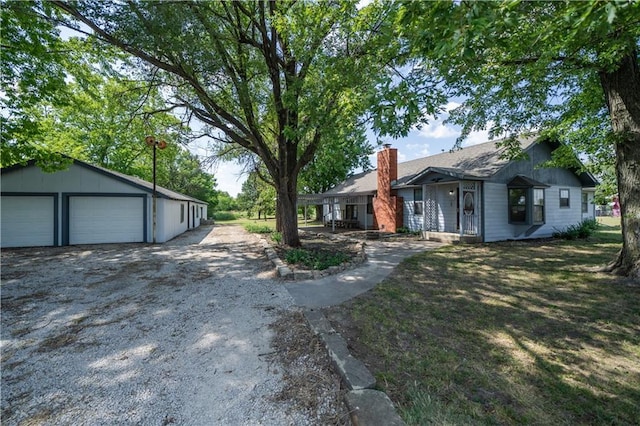 exterior space featuring a garage and an outdoor structure