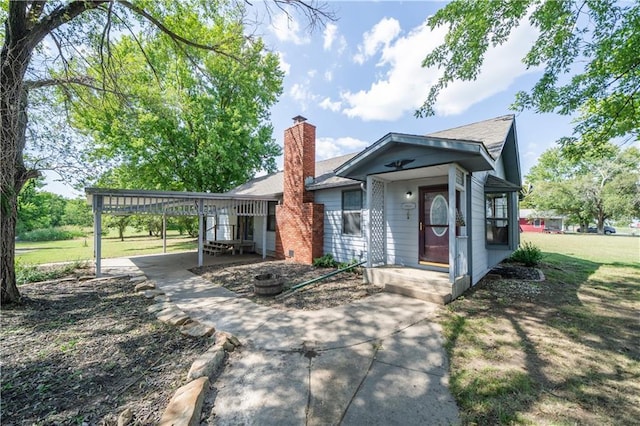 single story home featuring a front yard and a carport