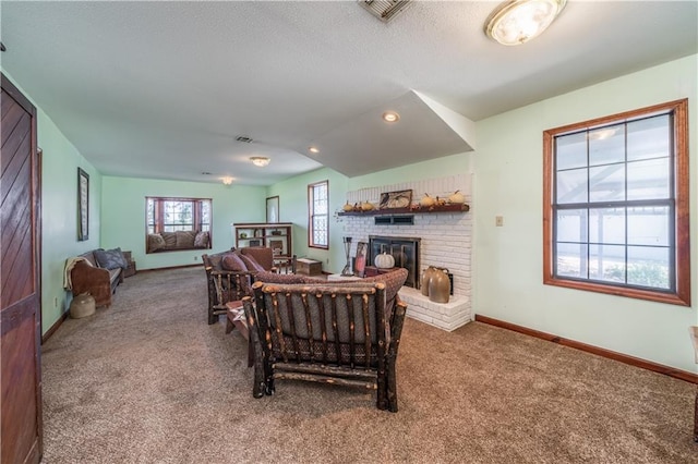 living room featuring a brick fireplace and carpet flooring