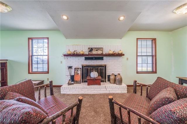 carpeted living room featuring a fireplace