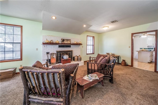 living room with a fireplace and light carpet