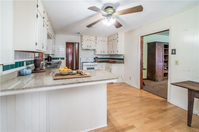 kitchen with sink, white cabinetry, light wood-type flooring, white range with gas cooktop, and kitchen peninsula