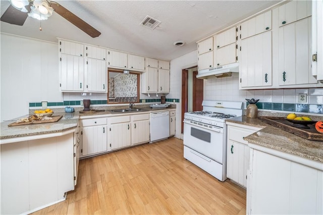 kitchen featuring white cabinetry, backsplash, white appliances, a textured ceiling, and light hardwood / wood-style flooring