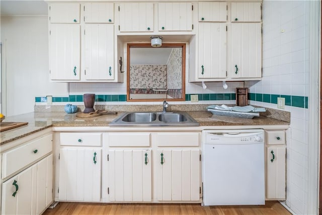 kitchen featuring sink, white cabinets, and white dishwasher