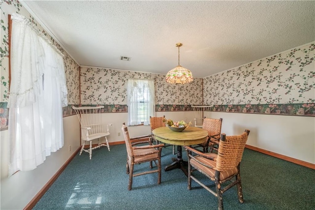 dining area featuring crown molding, carpet floors, and a textured ceiling