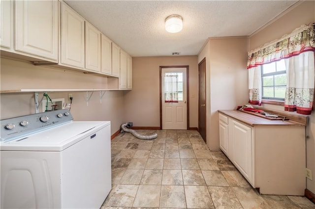 laundry room with washer / clothes dryer, a textured ceiling, and cabinets