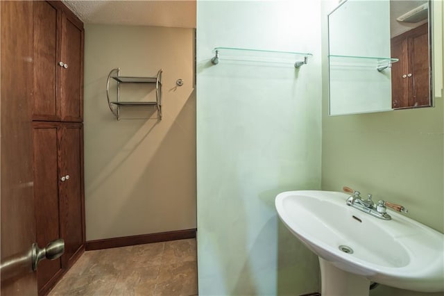 bathroom featuring sink and a textured ceiling