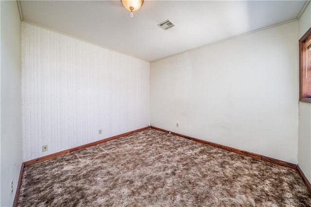 unfurnished room featuring ornamental molding and carpet flooring