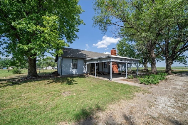 rear view of property with a yard