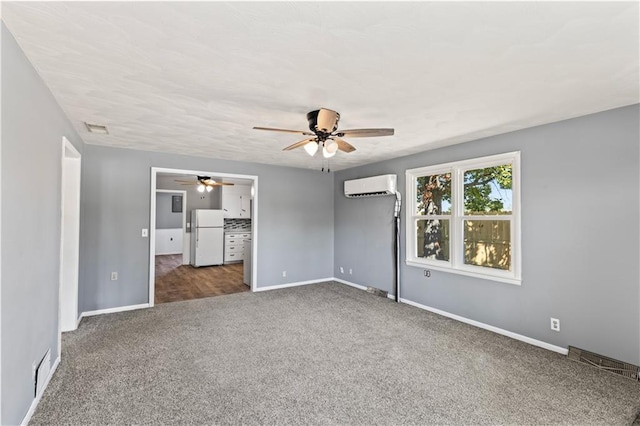 unfurnished bedroom with a wall unit AC, ceiling fan, dark carpet, and white refrigerator