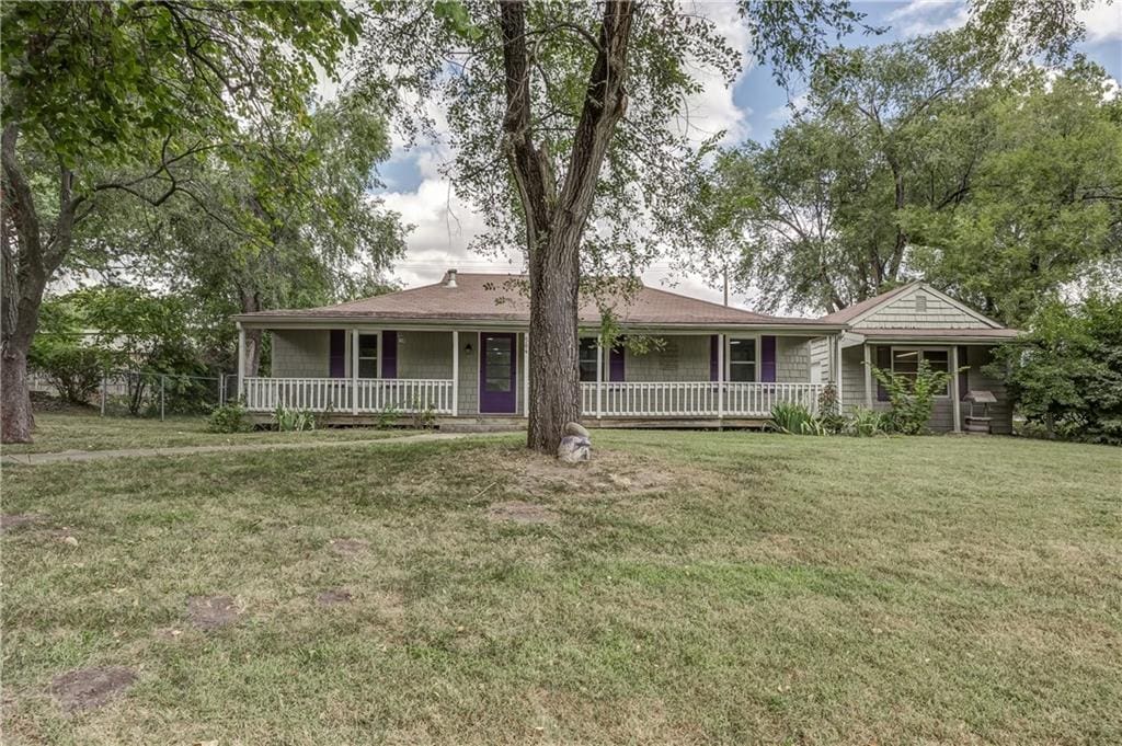 exterior space with a porch and a lawn